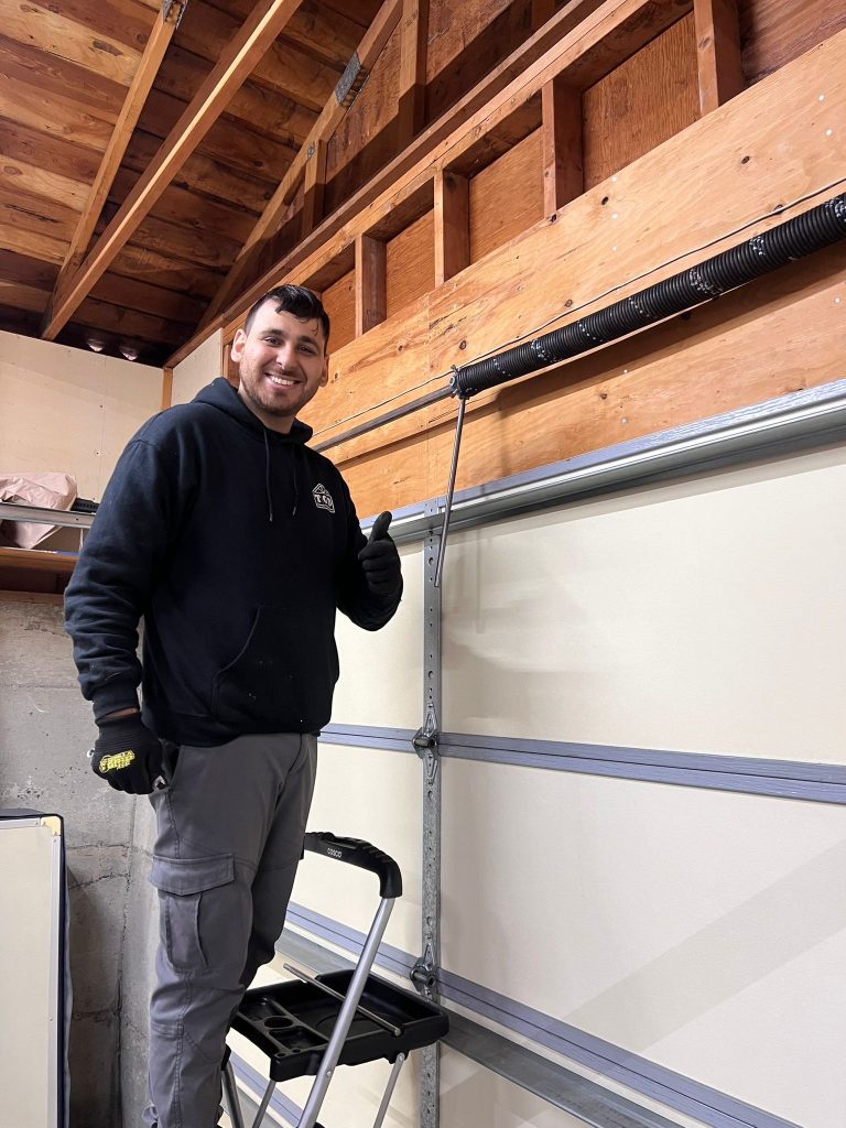 garage door repair technician working tomys garage door